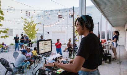 woman DJ's on patio of Inkwell Bar